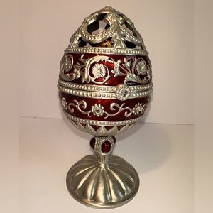 Scrolled  Egg is 6.5” X  3.5” and has substantial weight. It’s a music box.